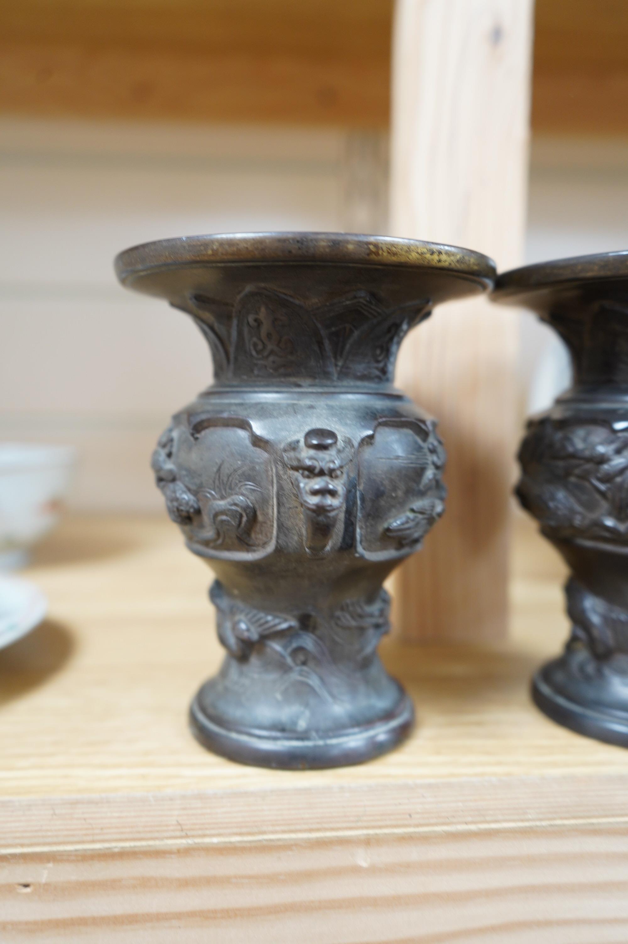 A pair of Japanese bronze vases, Meiji period, one signed, one lacking base, 13cm. Condition - fair